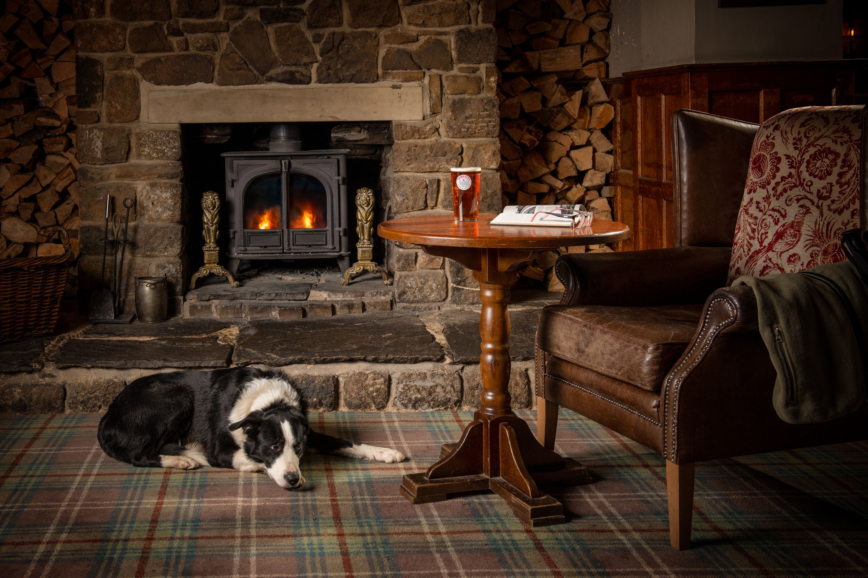 sheep dog by fire golden lion settle with pint of thwaites