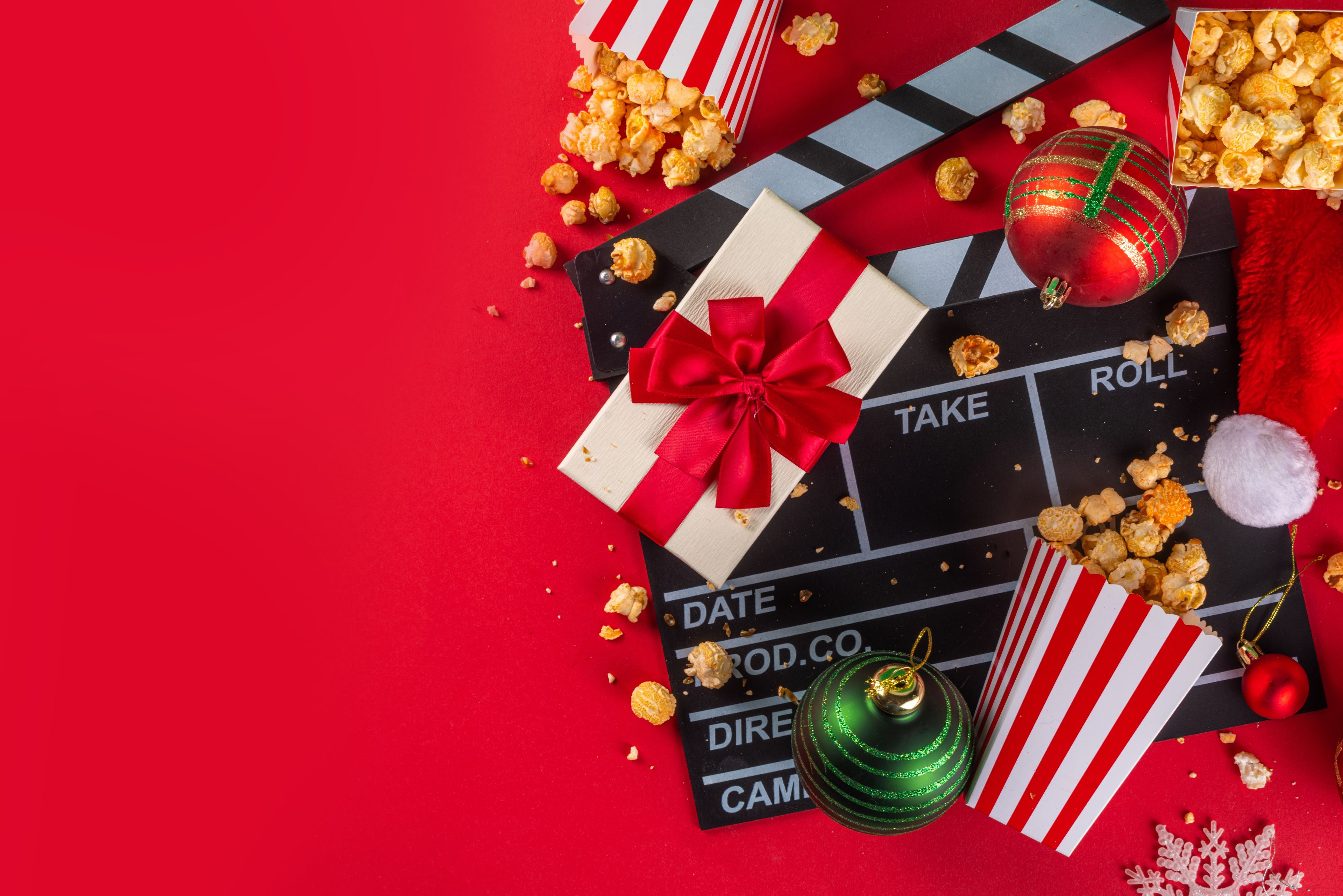 christmas decorations, popcorn, gift and movie clapperboard