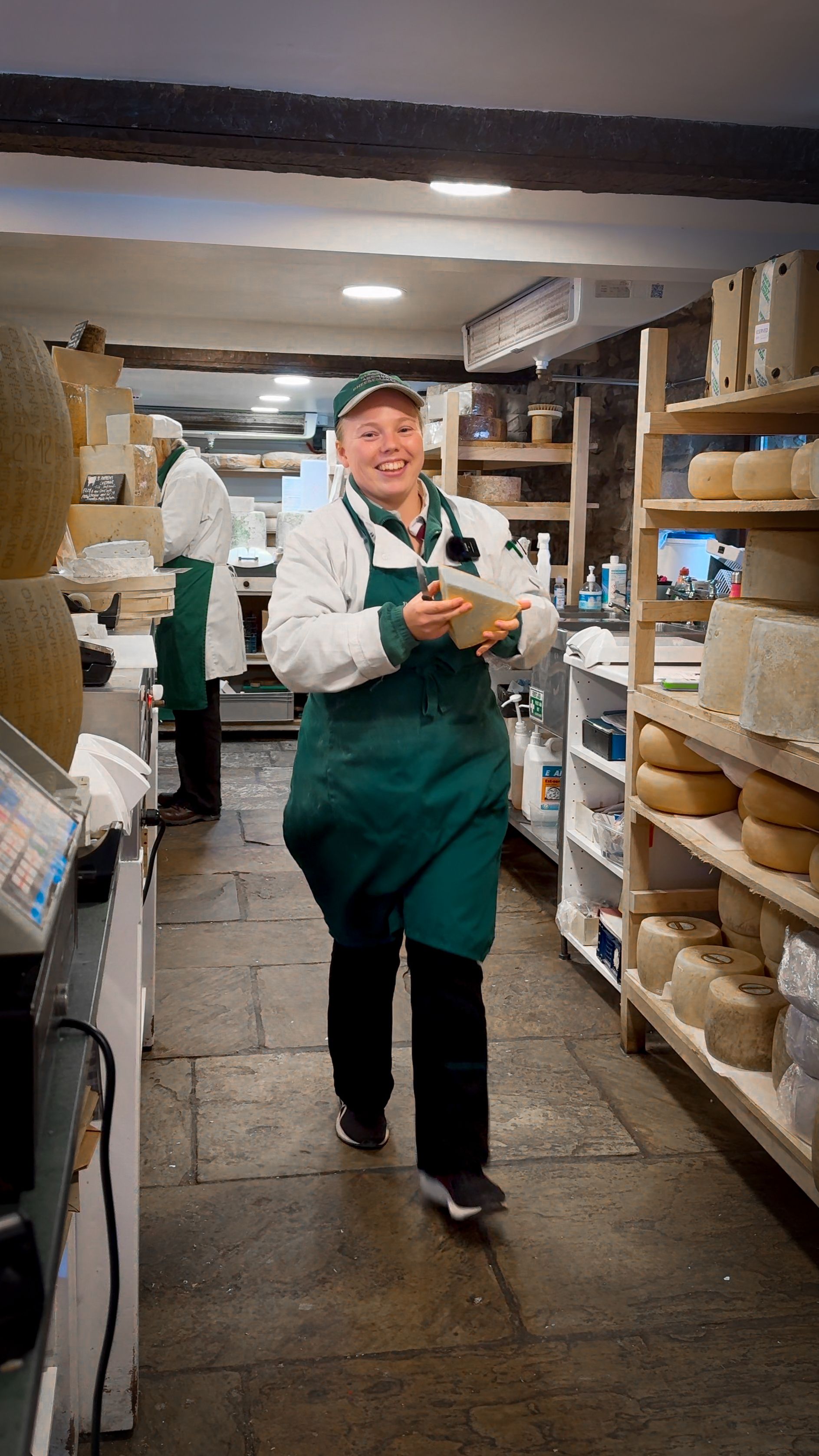 lady at courtyard dairy holding cheese